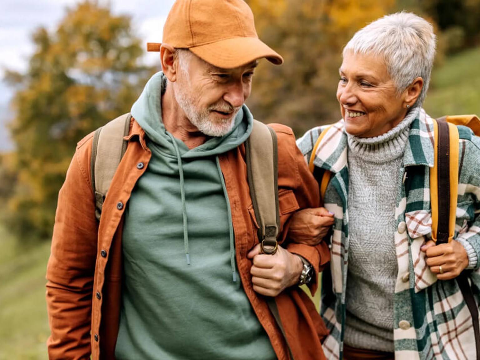 Older couple walking through a field